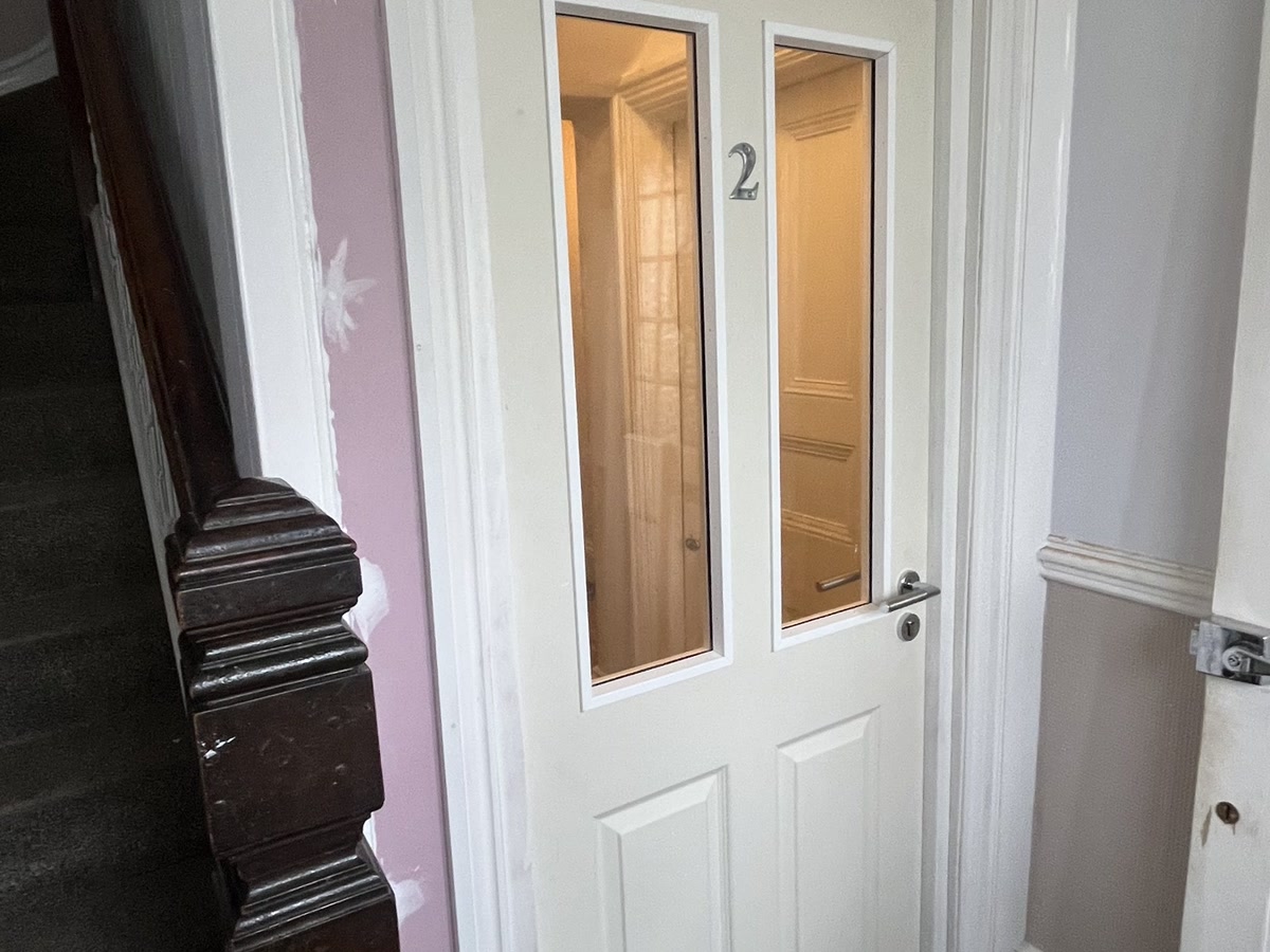 Glazed fire door installed in a residential block