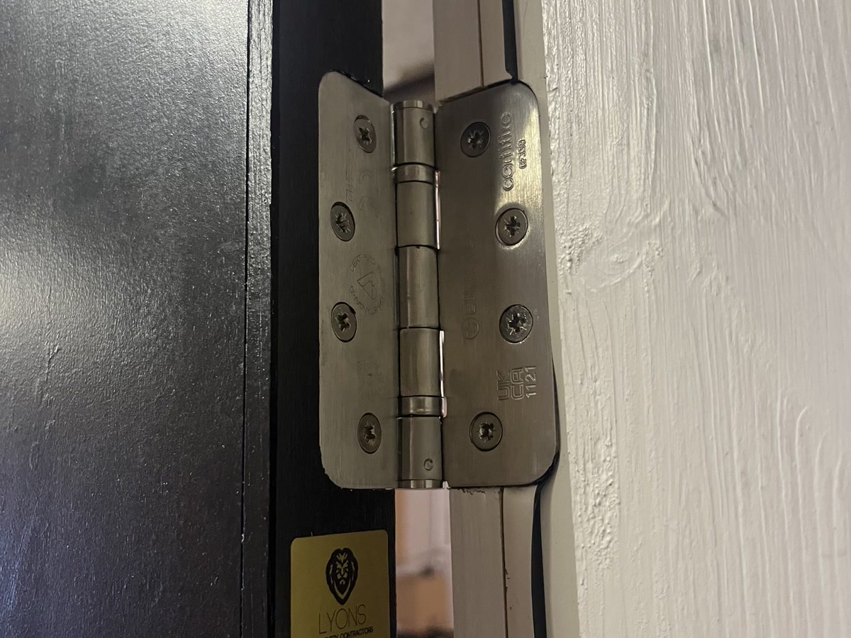 Fire-rated hinge detail with Lyons compliance tag